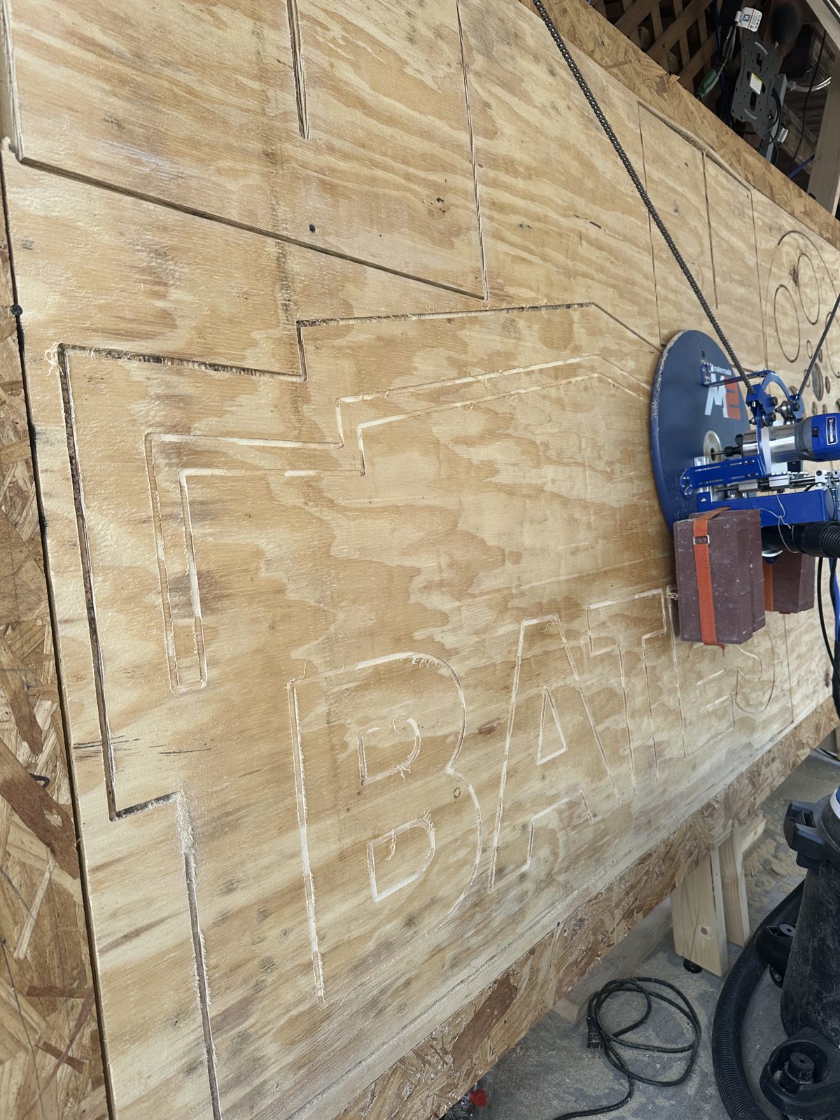 CNC router carving Bates Motel letter outlines into plywood