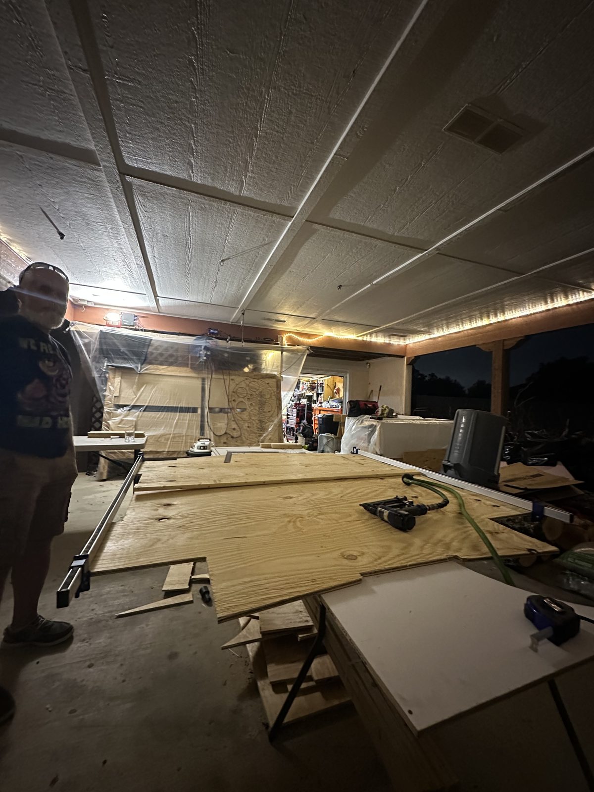 Two halves of a CNC-cut plywood Bates Motel sign clamped together for gluing and nailing